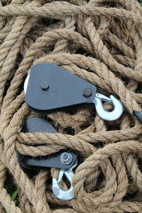 High angle view of hooks on ropes at harbor