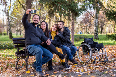 Young couple sitting on park bench