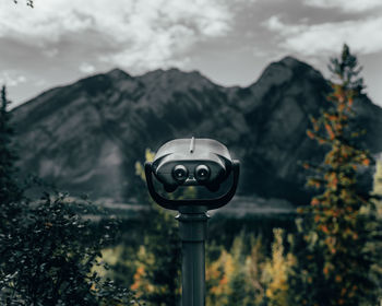 Coin-operated binoculars against sky