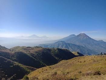 Scenic view of mountains against clear blue sky