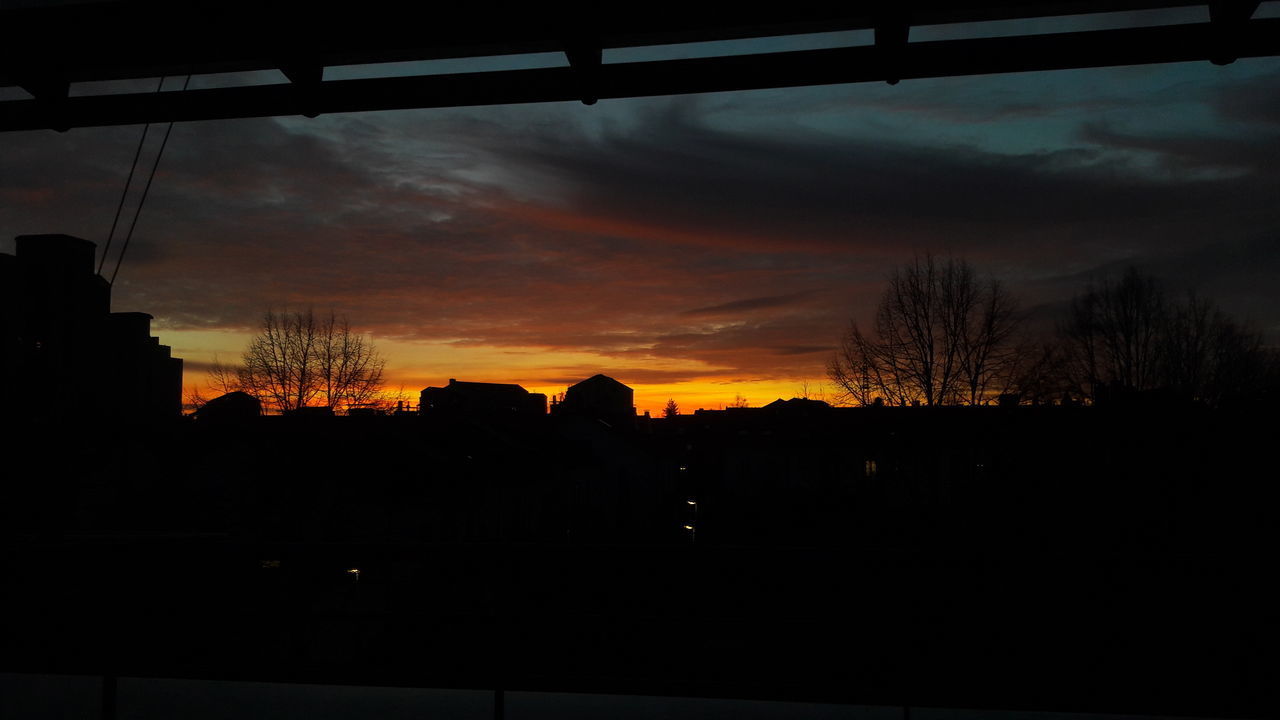 SILHOUETTE TREES AND BUILDINGS AGAINST SKY AT SUNSET