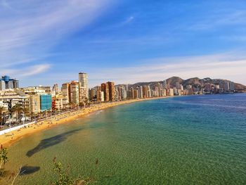 Scenic view of sea and buildings against sky