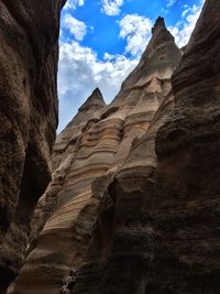 Low angle view of rock formation against sky