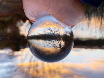 Close-up of hand holding crystal ball