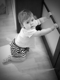 Portrait of cute boy sitting at home