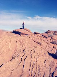 Father and daughter on rock