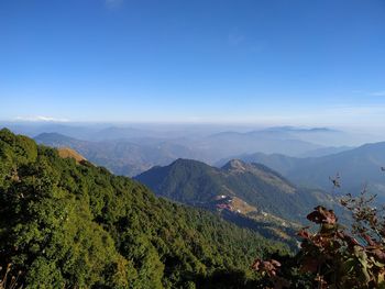 Scenic view of mountains against clear blue sky