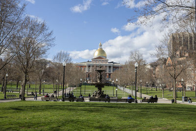 Massachusetts state house with park area and benches for people to relax