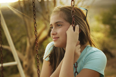 Close-up of girl holding chains