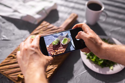 Midsection of man using mobile phone