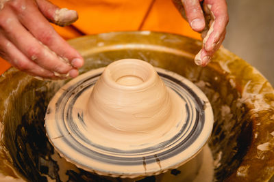 Cropped hands of man working in workshop