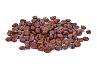 Close-up of coffee beans against white background