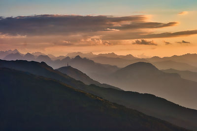 Scenic view of silhouette mountains against sky during sunset