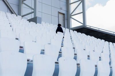 White seats in the stadium. child looks into the distance