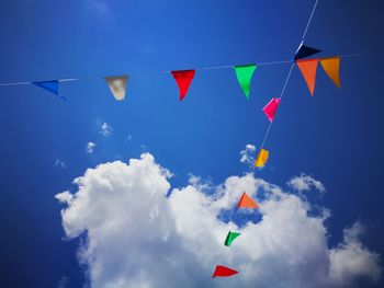 Low angle view of flags against sky