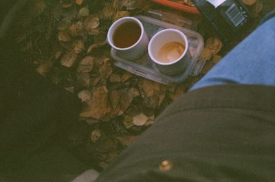 Low section of person holding coffee cup