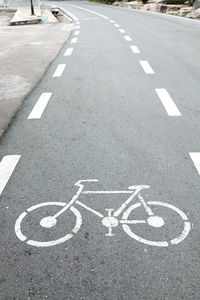 High angle view of arrow symbol on road in city