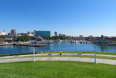 Scenic view of river by city against clear sky