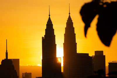 Silhouette of buildings against sky during sunset