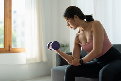 Young woman exercising in gym