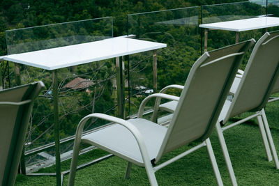Empty chairs and table in garden
