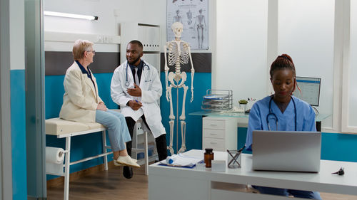 Female doctor examining patient in clinic