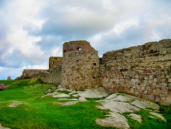 Old ruins of building against cloudy sky