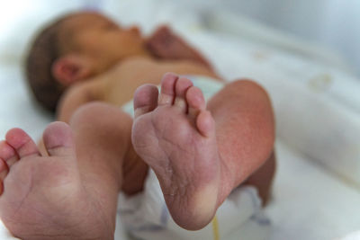 Close-up of baby sleeping on bed