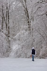 Rear view of woman on snow covered land