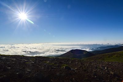 Scenic view of landscape against sky on sunny day