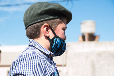 South american boy wearing face mask and traditional clothing