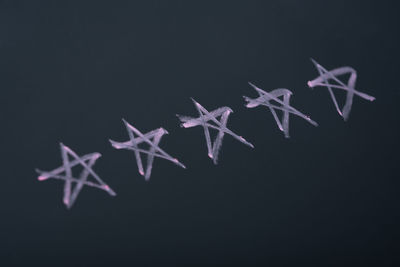 Close-up of snowflakes on glass against black background