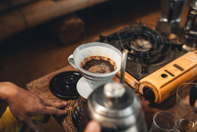 Cropped hand of woman preparing coffee