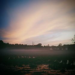 Scenic view of landscape against sky at sunset