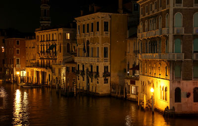 Canal passing through buildings at night