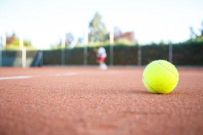 Close-up of yellow ball on tennis field