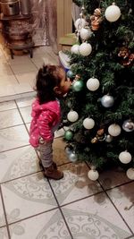 High angle view of girl and christmas tree on floor