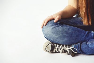 Low section of woman legs over white background