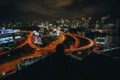 High angle view of illuminated city against sky at night