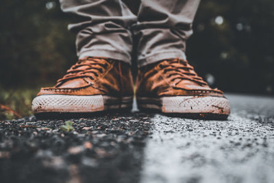 Low section of person standing on footpath