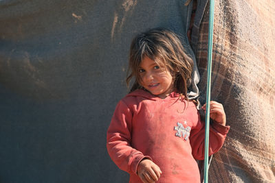 Portrait of young girl in a syrian refugee camp. 