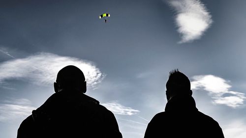 Low angle view of people against sky