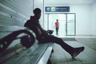 Side view of man walking in bus