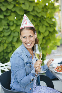 Young woman with champagne flute at crayfish party