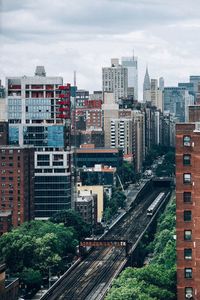 High angle view of railroad tracks amidst buildings in city