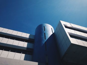 Low angle view of modern building against clear blue sky