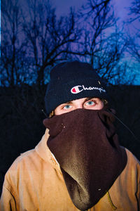 Portrait of man wearing hat against trees