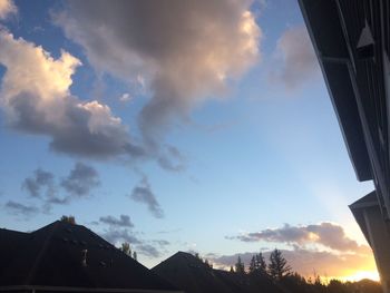 High section of silhouette mountain against clouds