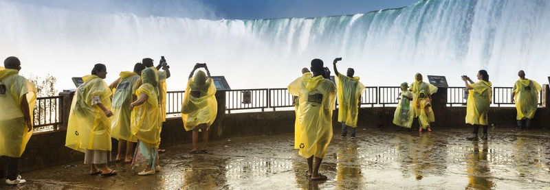 Rear view of people at beach during rainy season