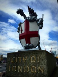 Low angle view of statue against sky in city